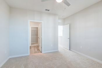 bedroom with carpet and en-suite bathroom at Tapestry Nona Apartments in Orlando, FL