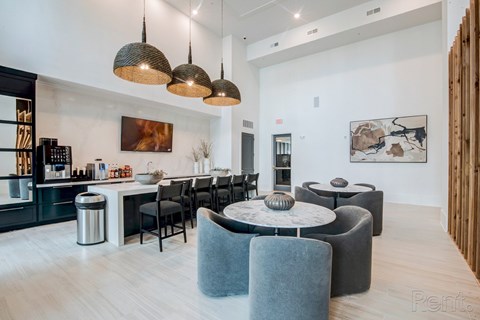 A modern living room with a grey sofa and a round table.