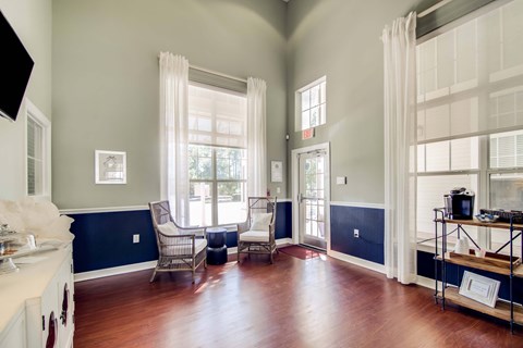 A living room with a white sofa and a wooden floor.