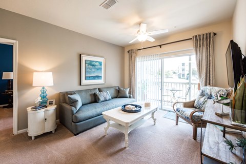 A living room with a grey couch and a white coffee table.