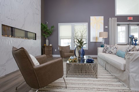 A living room with a brown chair and a white couch.