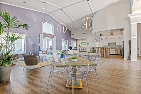 A modern dining room with a glass table and chairs.