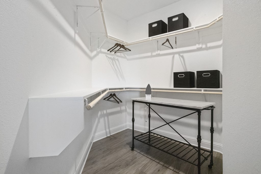 a room with white walls and a table in the corner