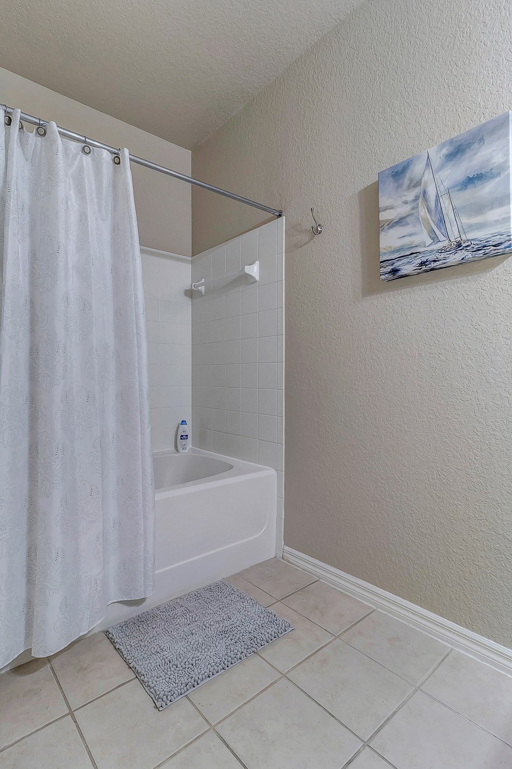 Guest bathroom with tile flooring at Bermuda Estates Apartments in Ormond Beach, FL