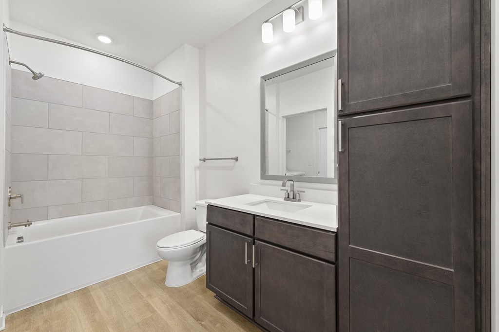 a bathroom with wood style flooring at Tapestry Overbrook in McDonough, Georgia