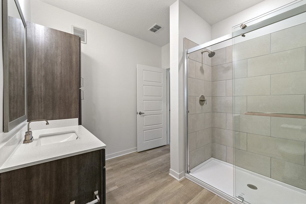 bathroom with quartz countertops, designer lighting, and undermount sinks at Tapestry Overbrook in McDonough, Georgia