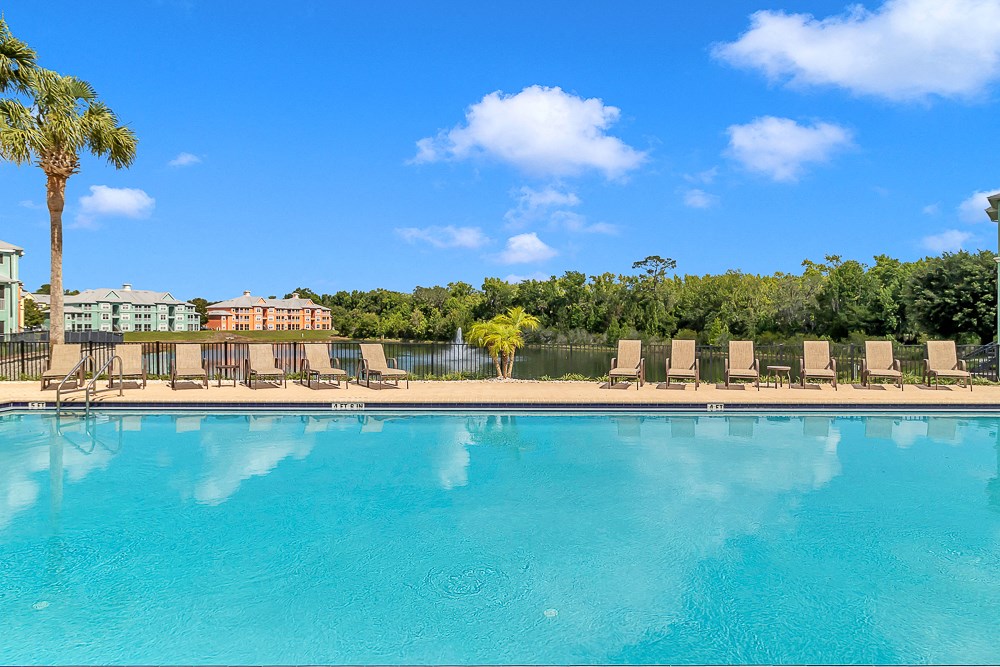 Swimming pool and sundeck at Bermuda Estates Apartments in Ormond Beach, FL