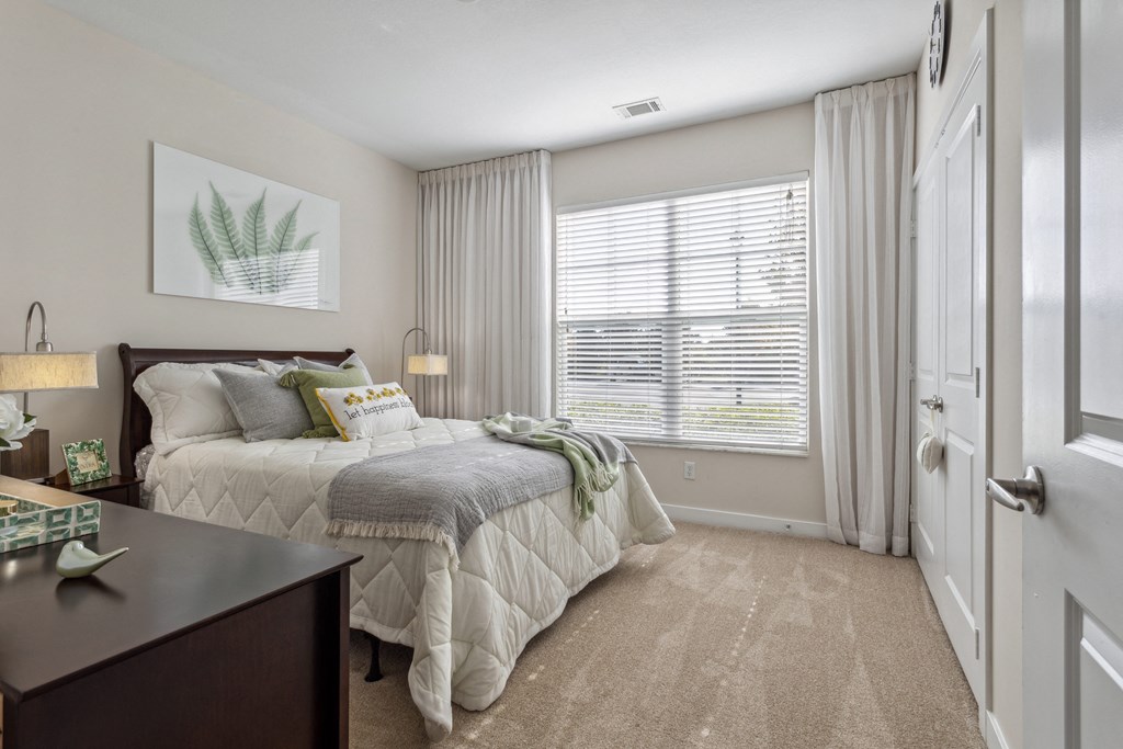 a bedroom with a bed and a dresser and a window at Hampton Roads Crossing, Virginia, 23435