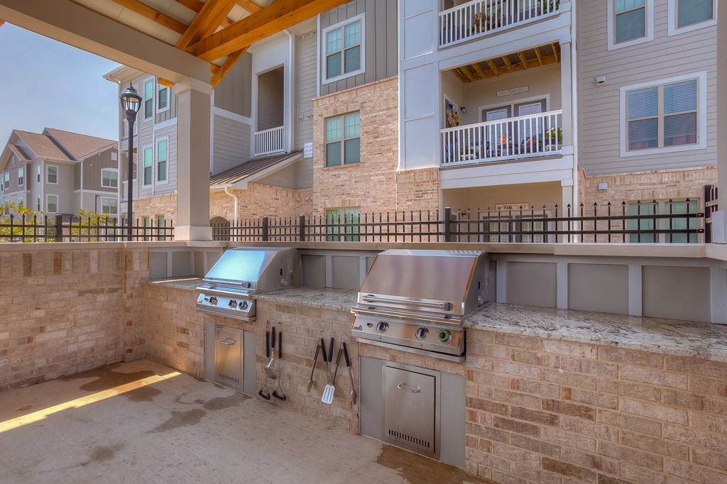 an outdoor kitchen with stainless steel appliances