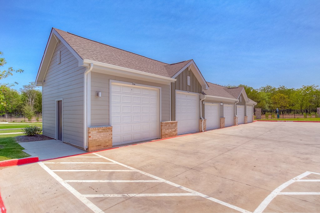 a row of garages at the whispering winds apartments in pearland, tx