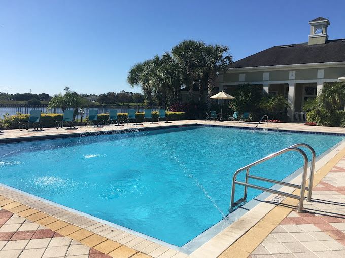 Pool with seating overlooking lake at Legacy at Crystal Lake Apartments in Port Orange, Florida Swimming pool at Legacy at Crystal Lake Apartments in Port Orange, Florida - Photo Gallery