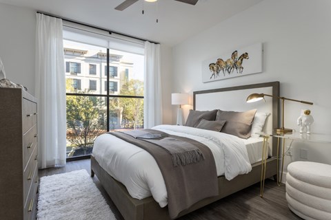 Modern bedroom with platform bed and natural lighting at 2020 Providence Apartments, Alabama, 35806