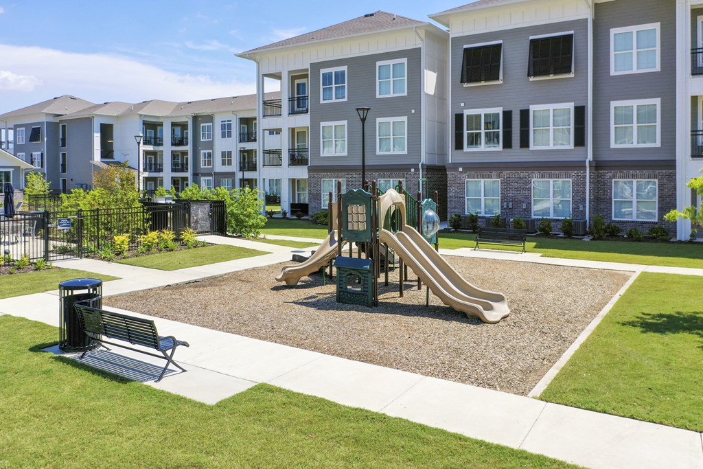 a playground in front of an apartment building