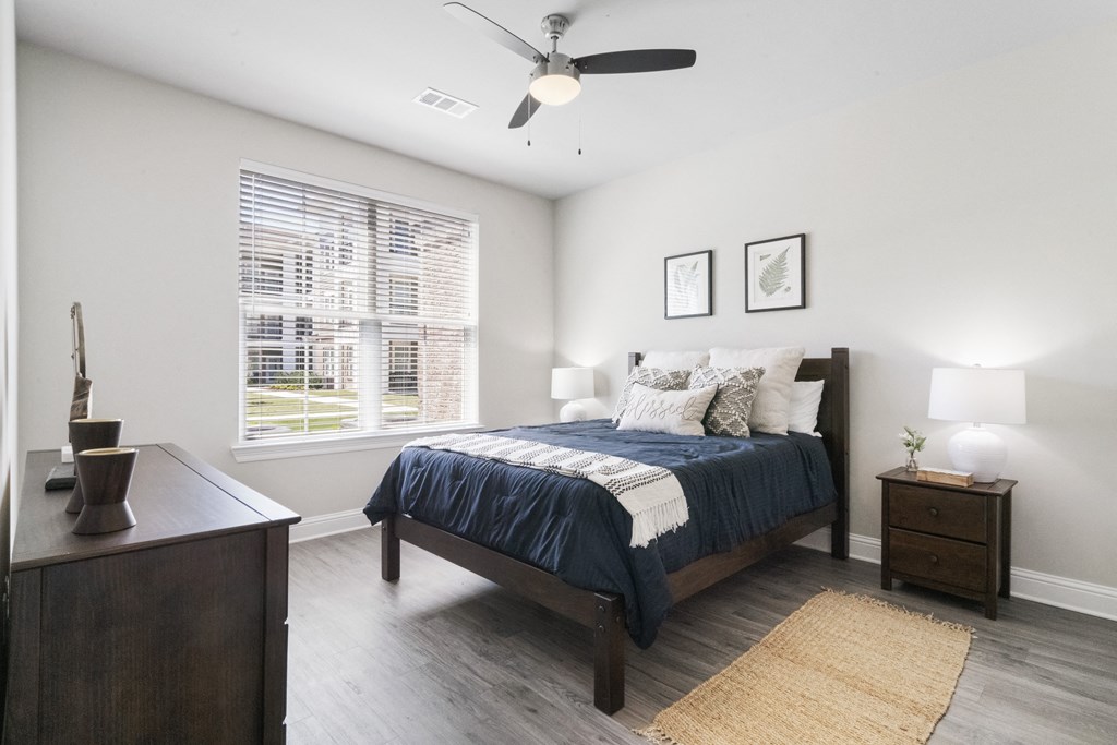 a bedroom with a bed and a ceiling fan