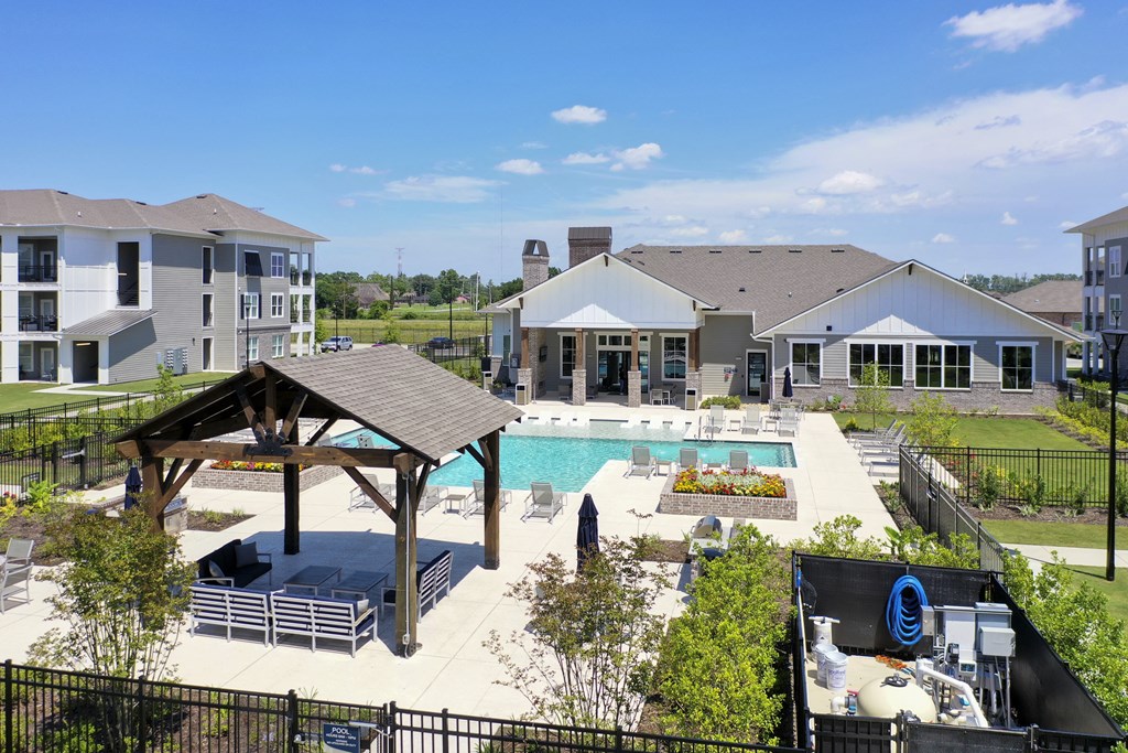 an aerial view of a swimming pool with apartments in the background