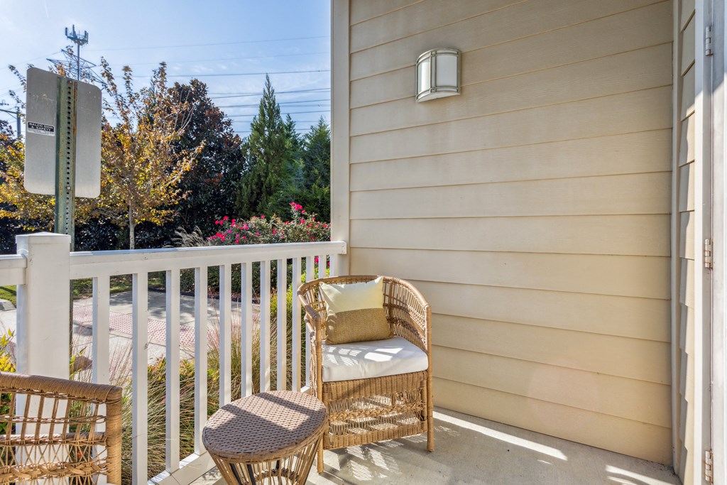 a patio with two chairs and a table on a porch at Hampton Roads Crossing, Suffolk, 23435