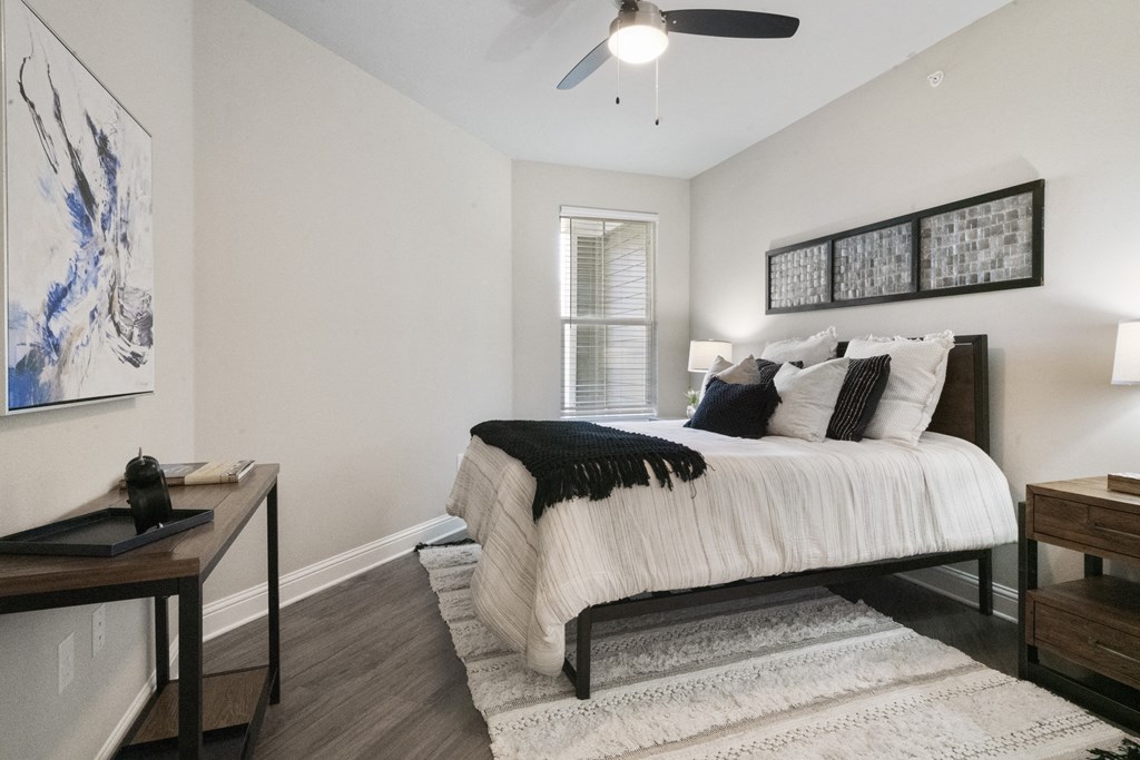 a bedroom with a bed and a ceiling fan
