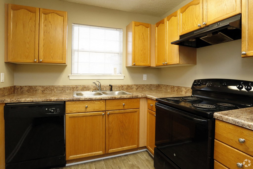 a kitchen with black appliances and wooden cabinets