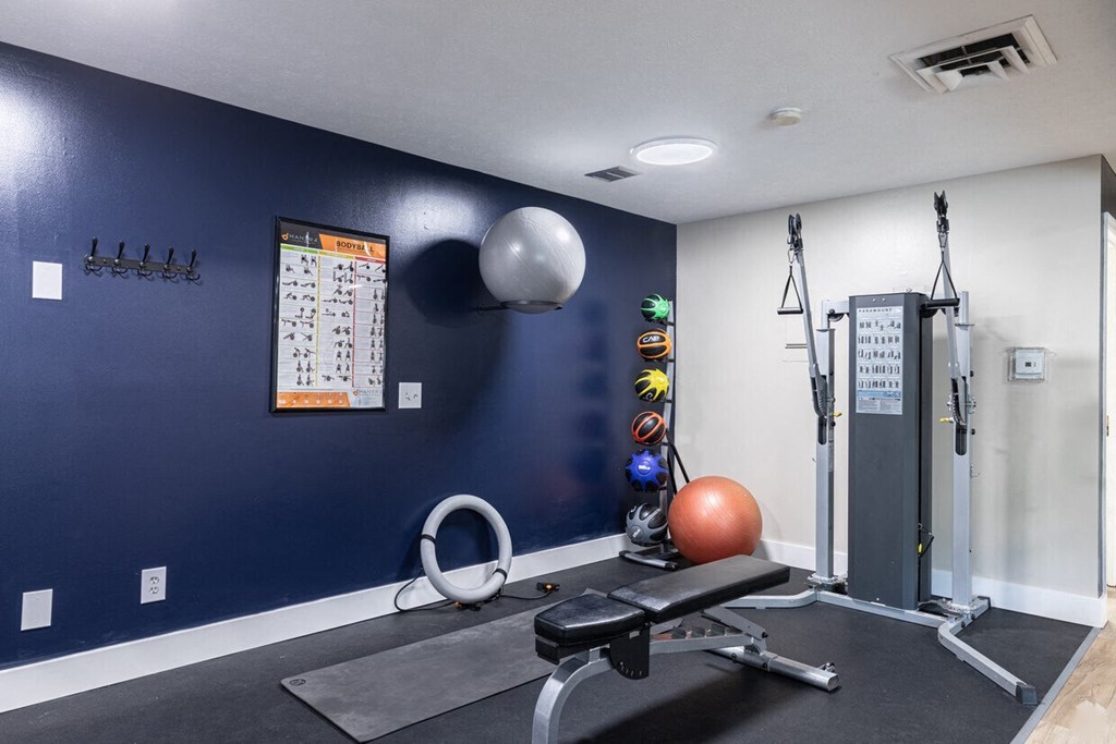 a home gym with a navy blue accent wall