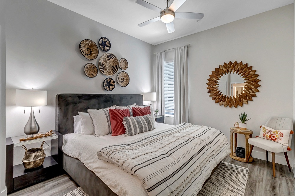 a bedroom with a bed and a ceiling fan