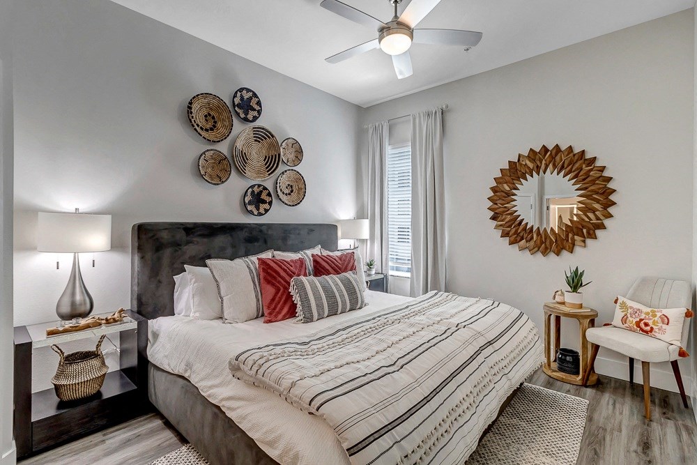 a bedroom with a bed and a ceiling fan