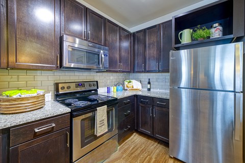 a kitchen with stainless steel appliances and wooden cabinets