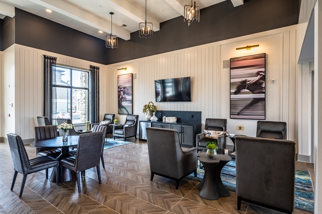 a resident clubhouse with tables and chairs and a fireplace