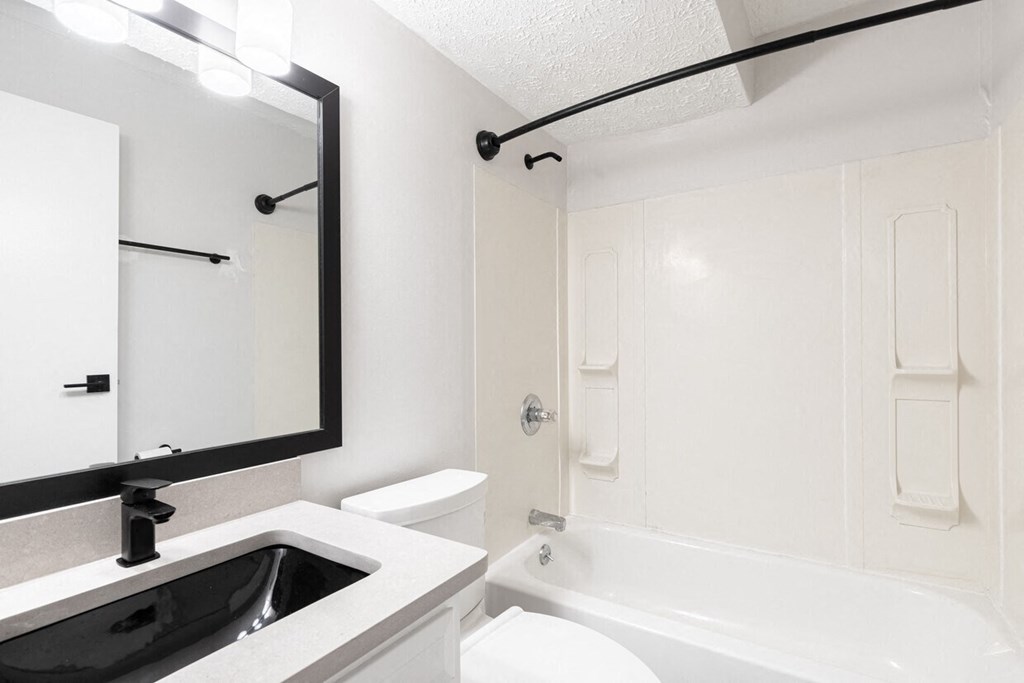 a bathroom with a sink toilet and bathtub