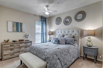 master bedroom with plush carpet and en-suite bathroom at Bermuda Estates Apartments in Ormond Beach, FL Spacious Bedrooms with Natural light at Bermuda Estates Apartments in Ormond Beach, FL