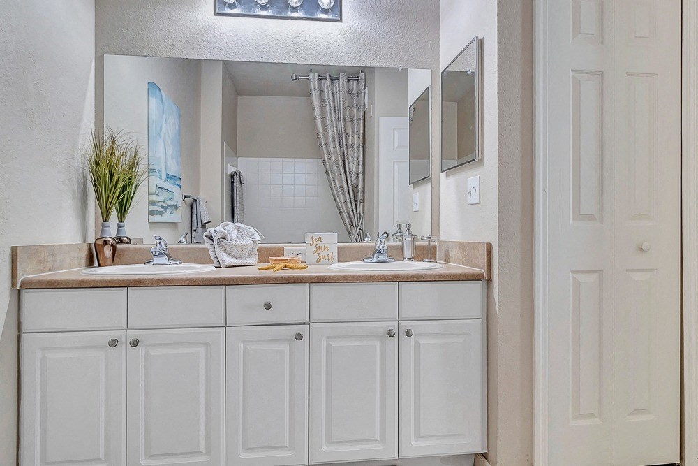 bathroom with cabinets and large vanity at Bermuda Estates Apartments in Ormond Beach, FL
