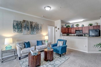 Spacious living and kitchen with ample cabinet space at Bermuda Estates Apartments in Ormond Beach, FL Open Concept Living and Kitchen at Bermuda Estates Apartments in Ormond Beach, FL - Photo Gallery 4