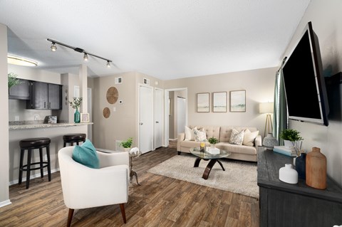 A living room with a white chair and a brown coffee table.
