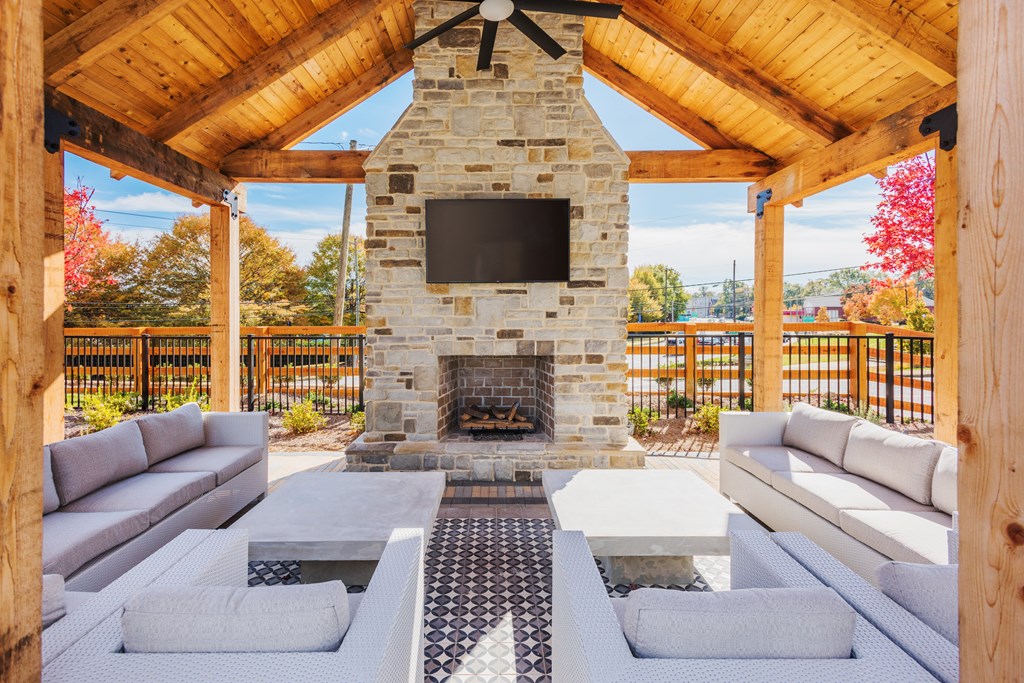 Poolside pavilion with fireplace, TV, and seating area at Bon Haven apartment complex in Spartanburg, SC