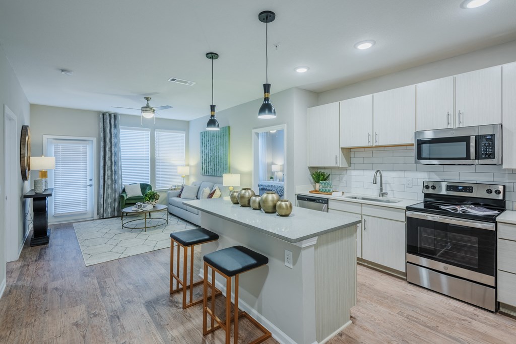 kitchen with custom cabinets, large island, and stainless steel appliances at Bon Haven Apartments in Spartanburg, SC