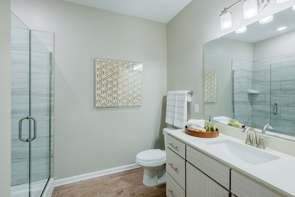 Modern bathroom with wood style floors and stand alone showers at Bon Haven Apartments in Spartanburg, SC