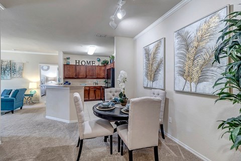 a dining room and kitchen with a table and chairs