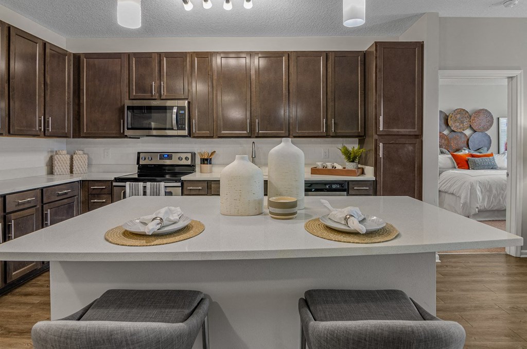 a kitchen with brown cabinets and a white counter top