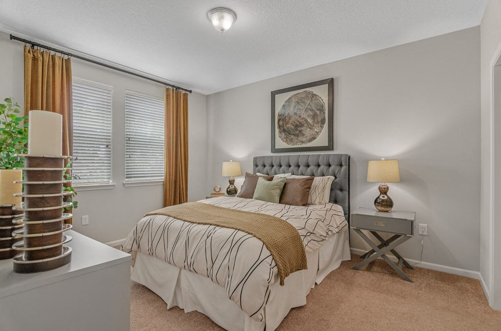 a bedroom with a bed and two windows