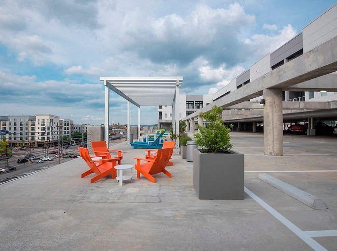 a group of orange chairs sitting outside of a building