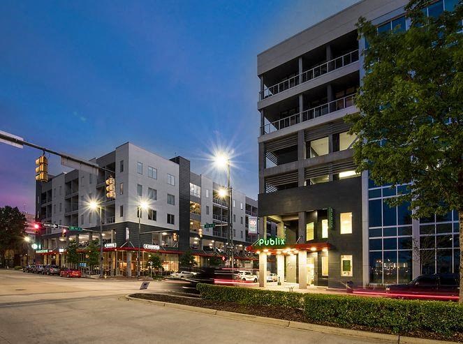 a city street at night with buildings and street lights
