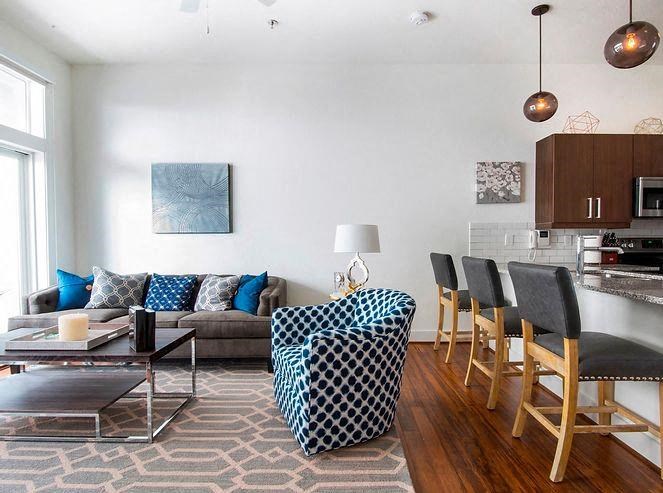 a living room and kitchen with a table and chairs