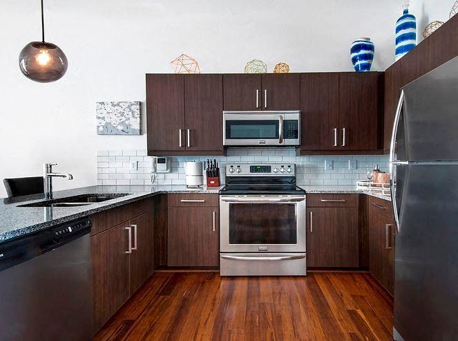 a kitchen with stainless steel appliances and wooden cabinets