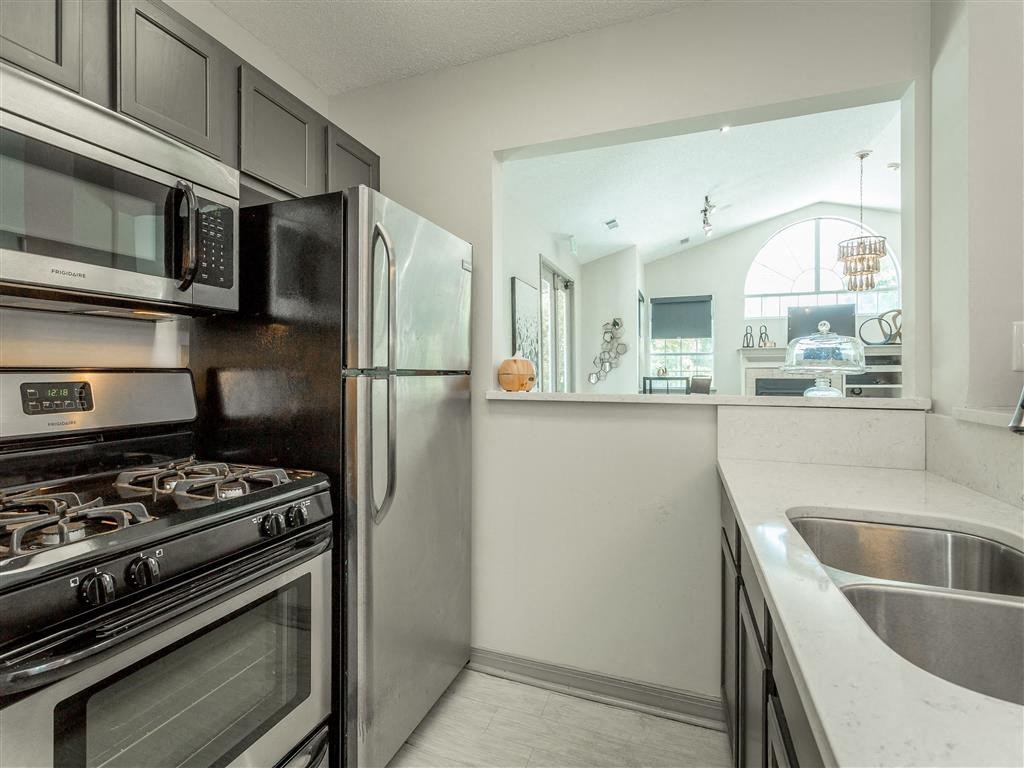 a kitchen with stainless steel appliances and a sink