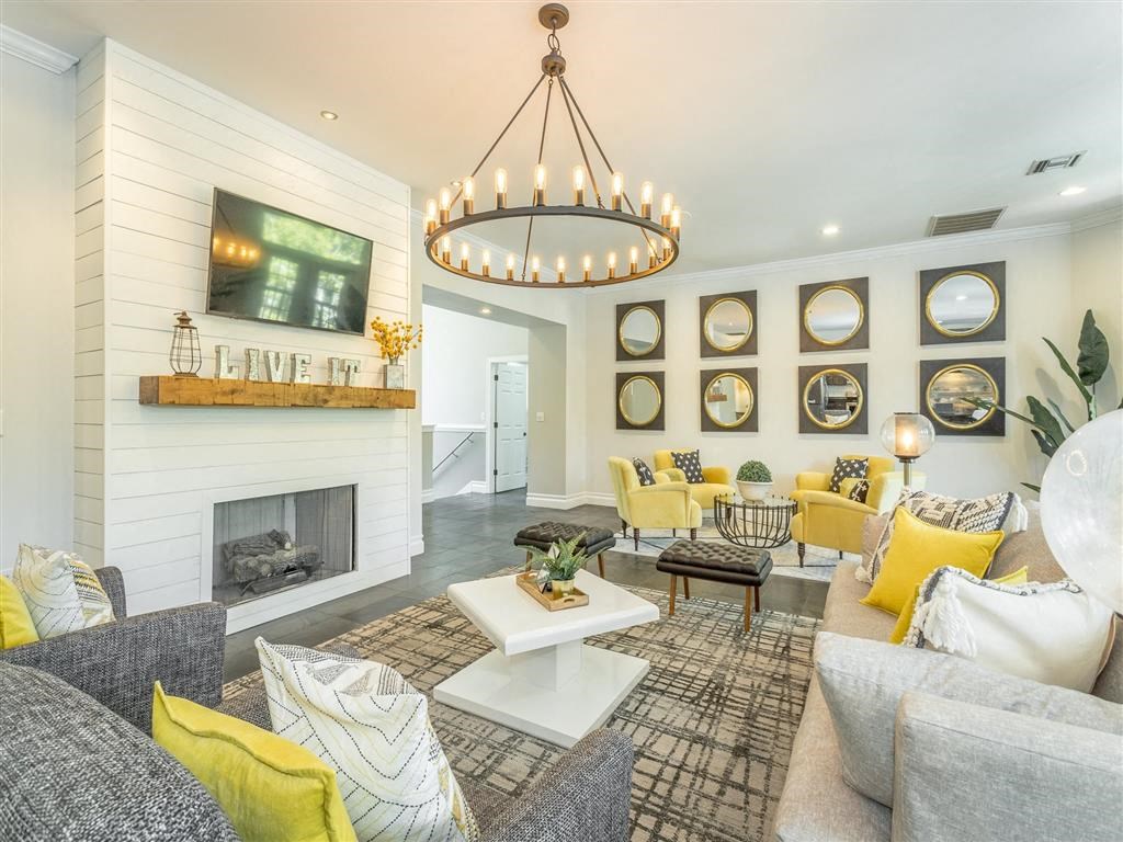 a living room with a fireplace and a chandelier