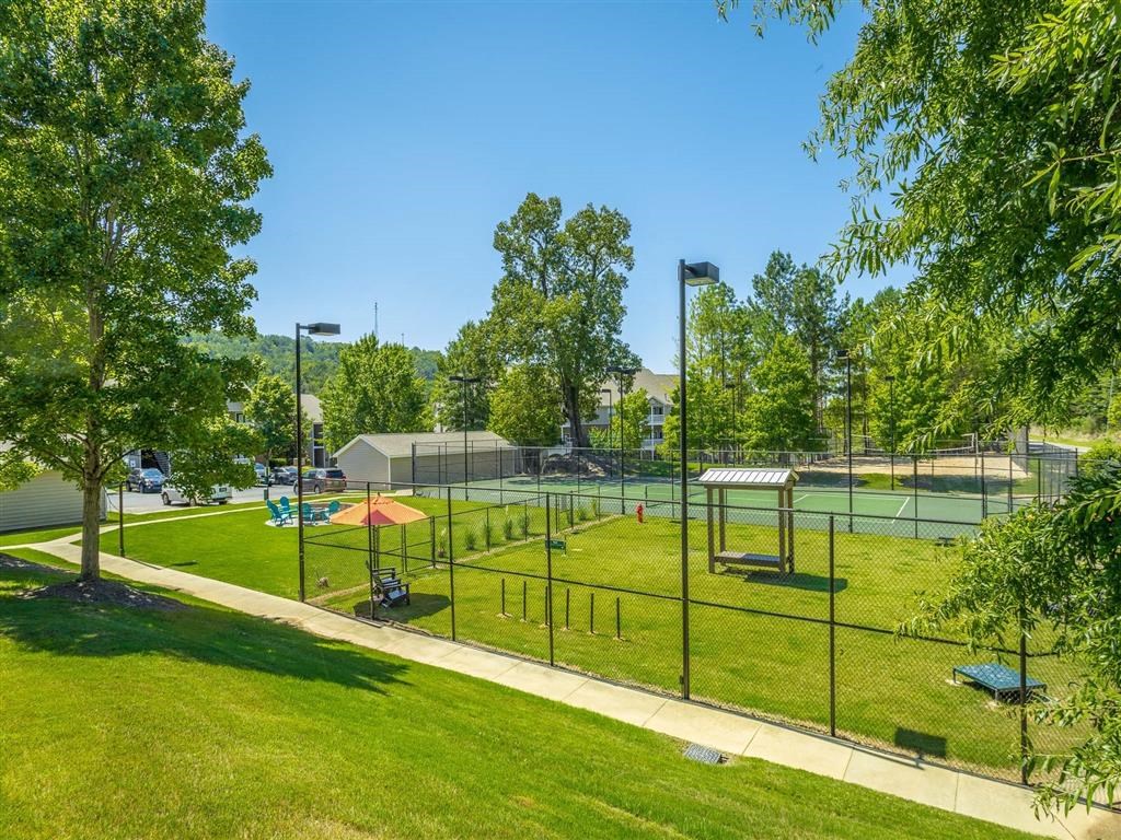 a park with a playground and a tennis court