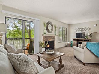 the living room has a fireplace and a sliding glass door to the patio