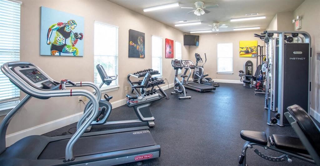 a gym with cardio machines and other exercise equipment