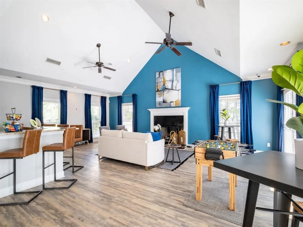 a living room with a blue wall and a fireplace