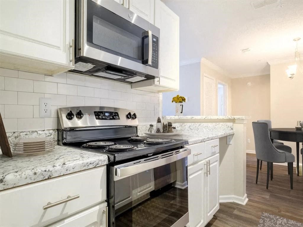 a kitchen with a stove and a microwave