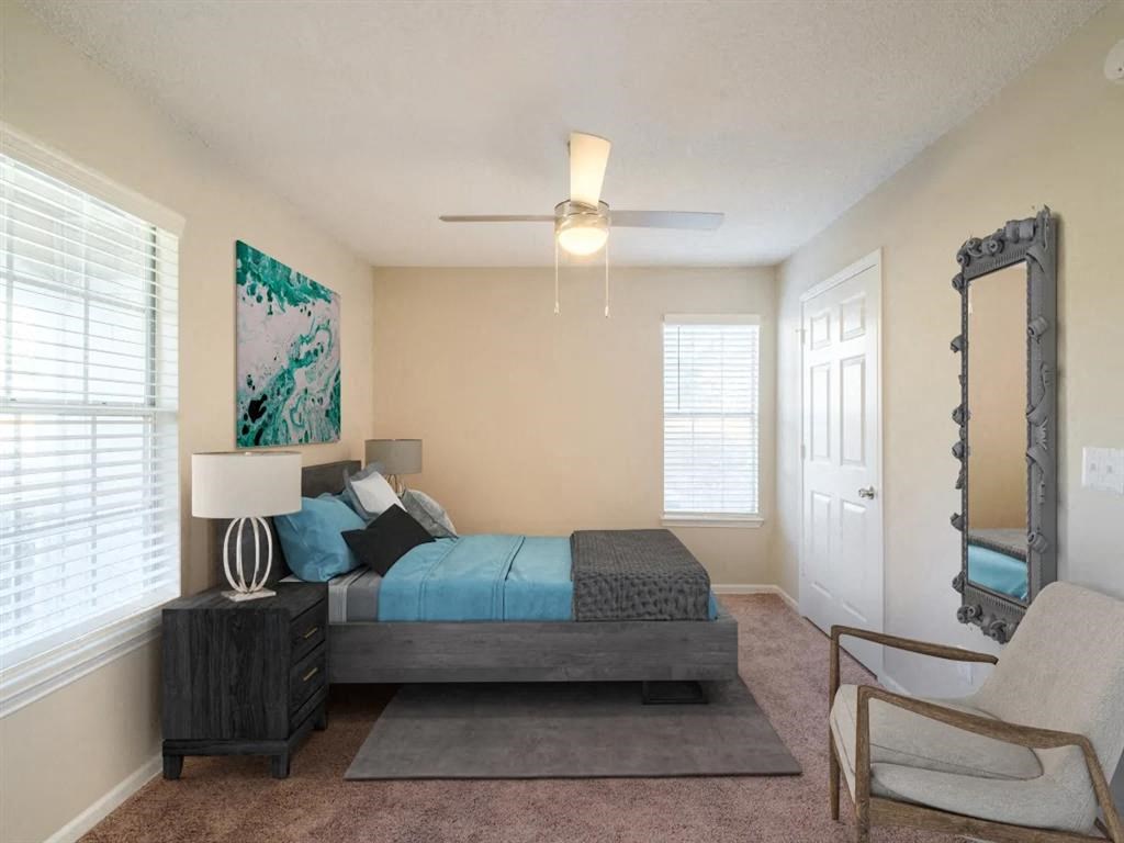 a bedroom with a bed and a ceiling fan